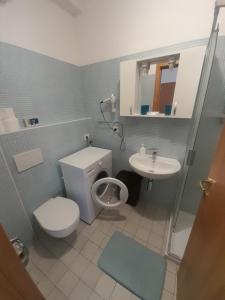 a bathroom with a toilet and a sink at Monlocale al 20m del mare con terrazza privata in Roseto degli Abruzzi +16 photos
