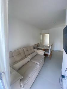 a living room with a couch and a table at Lar caminho da Ilha in Igarassu
