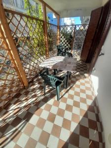 a balcony with a table and chairs on a checkered floor at Monlocale al 20m del mare con terrazza privata in Roseto degli Abruzzi