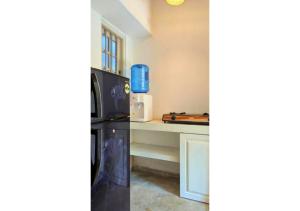 a kitchen with a refrigerator and a counter at South Roots in Unawatuna