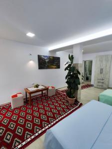 a living room with a couch and a table at Sokaku Apartment in Gjirokastër +16 photos