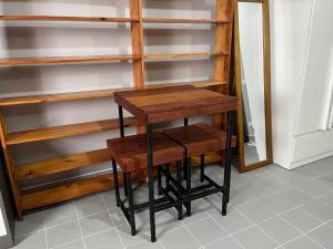 a wooden shelf with a stool in a closet at Impact Arena C5 by Jintana in Thung Si Kan +74 photos