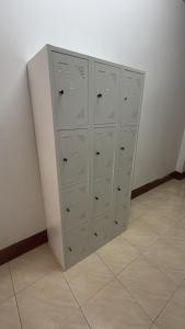 a row of lockers in a room with a wall at Klong Muang Hostel คลองม่วงโฮสเทล in Ban Ko Kwang