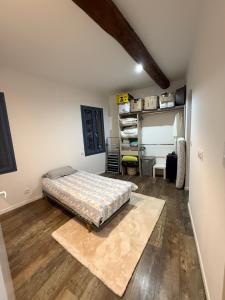 a bedroom with a bed on a wooden floor at Blue house in Saint-Gilles