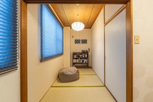 a hallway with a room with a window at Guest Houseふくふく in Shimonoseki