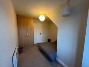 a small room with a bed and a closet at Large 3 bed Duplex Apartment - Rhebogue Limerick in Limerick +2 photos