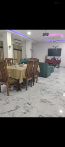 a living room with a table and chairs and a couch at Panahh in Guwahati