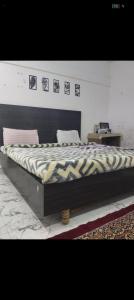 a large bed sitting in a bedroom with at Panahh in Guwahati