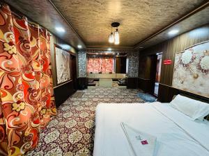a hotel room with a bed and a window at Id villa in Tangmarg
