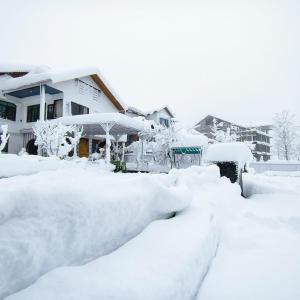 a pile of snow in front of a house at Id villa in Tangmarg