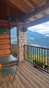 a porch of a cabin with a bench on the deck at B&B Val Maschi in Lamon