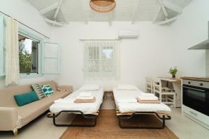 a living room with a couch and a table at Varka Bungalows in Methoni