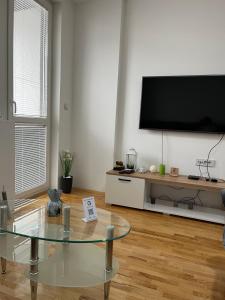 a living room with a large flat screen tv on a wall at Pantelej gates in Niš
