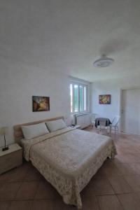 a bedroom with a bed and a table and chairs at Villa Aurora in Tirrenia