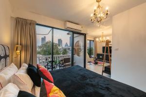 a bedroom with a bed and a view of the city at Studio Kunst in Bangkok