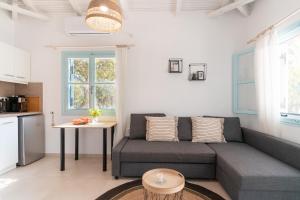 a living room with a couch and a table at Varka Bungalows in Methoni +59 photos