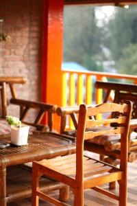 a wooden table and chairs on a porch at Swindo Homestay 77, Room 1 in Berastagi