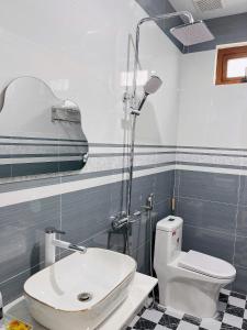 a bathroom with a white toilet and a sink at SUN Homestay Vĩnh Hy in Vĩnh Hy