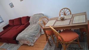 a living room with a couch and a table at Adela Mountain View Sinaia in Sinaia