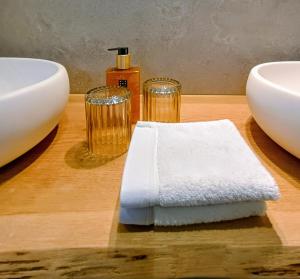 a wooden table with a white towel and two glasses at Au Coin du Bois in Theux