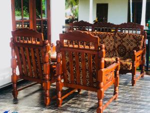 a group of chairs sitting next to each other at Lumora Resort in Nochchiyagama +5 photos