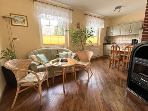 a kitchen and living room with a table and chairs at Ferienwohnung Anna in Benneckenstein