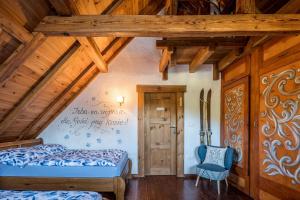 a bedroom with a bed and a chair in a room at Ranczo Pod Strzechą in Stara Kamienica