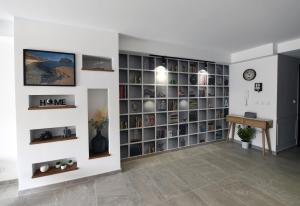 a living room with a large book shelf at Hal Wardija - Gozo Hideaways in Qala