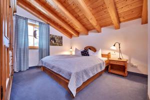 a bedroom with a bed and a large window at Föhrenhof Apartments in Farchant
