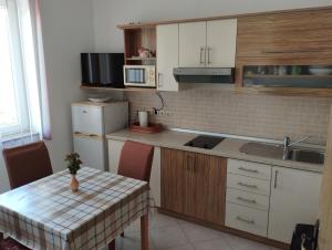 a kitchen with a table and a counter top at lopar 239 in Lopar