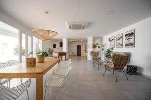 a room with chairs and a table and a dining room at Seafront 2B Apartment with Pool, Spa & Gym Torrox in Torrox