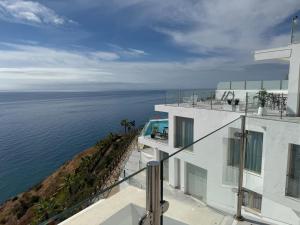 a view of the ocean from a building at Seafront 2B Apartment with Pool, Spa & Gym Torrox in Torrox