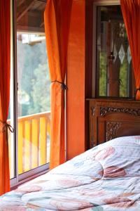 a bedroom with a bed and a window at Swindo Homestay 77, Room 11 in Berastagi