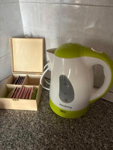 a tea kettle sitting on a counter next to a box at Molinella Appartamento Amelia & Carlo in Molinella