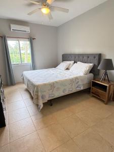 a bedroom with a bed and a ceiling fan at The Cove Apartments in El Francés +83 photos