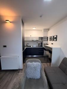 a living room with a couch and a kitchen at Perfect Place 32 in Varaždin