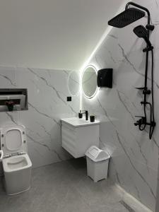 a white bathroom with a sink and a mirror at Gabala Central Villa in Gabala +35 photos