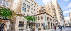 a group of people walking down a street with buildings at Jacob Harmony in Jerusalem