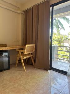 a room with a desk and a chair next to a window at Nest by Aerial Lanta in Ko Lanta