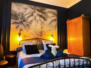 a bedroom with a bed with a stuffed animal on it at Château des Bourdons Charme, Spa & Nature in Varennes Vauzelles +53 photos