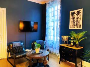 a living room with a couch and a table at Château des Bourdons Charme, Spa & Nature in Varennes Vauzelles