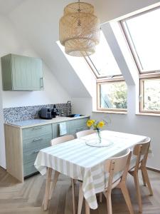 a kitchen with a table with chairs and a ceiling at Slow Life Rabka in Rabka-Zdrój