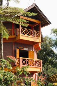 a tall building with a balcony on the side of it at Swindo Homestay 77, Room 11 in Berastagi