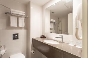 a bathroom with a sink and a mirror at Jacob Harmony in Jerusalem