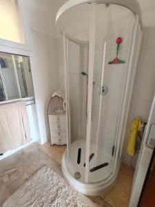 a shower with a glass door in a bathroom at Beautifull view at lake in Cima