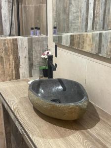 a bathroom with a large rock sink on a counter at casa in piazza in Pylos +25 photos