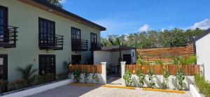 a house with a fence in front of it at Live bambu in Caimital