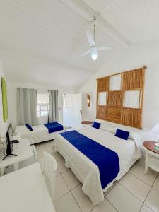 a bedroom with two beds and a table at Pousada Bucaneiro in Búzios +45 photos