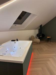 a large bath tub in a room with a ceiling at Intramuros in Muros +129 photos