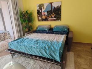 a bedroom with a bed with blue sheets on it at Beautifull view at lake in Cima
